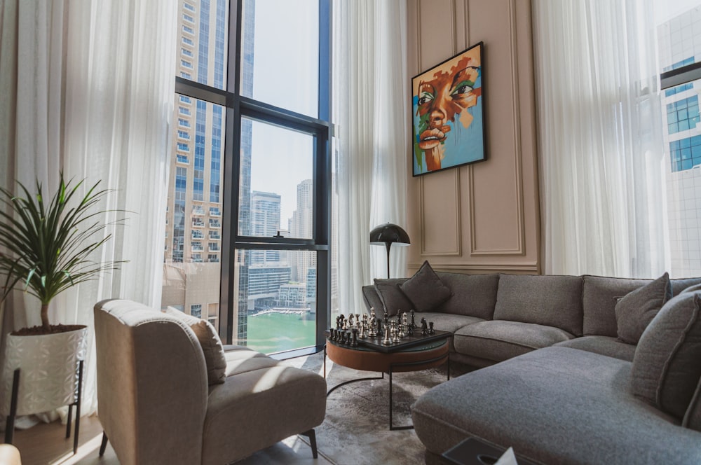 a living room filled with furniture and a large window