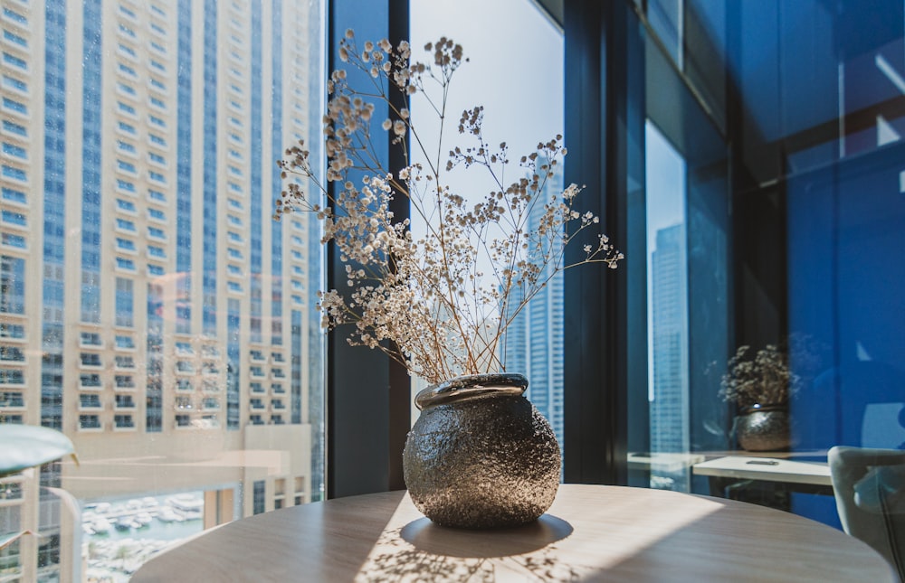 a vase filled with flowers sitting on top of a table