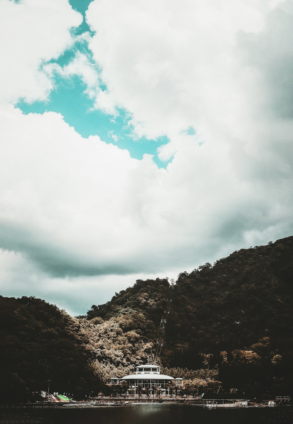 a boat floating on top of a lake under a cloudy sky