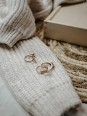 Set of wooden rings with fine laser-engraved details, arranged artistically on a soft fabric.