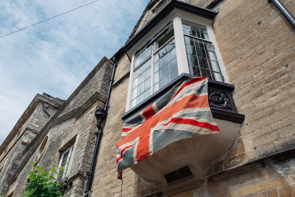 a flag hanging from the side of a building