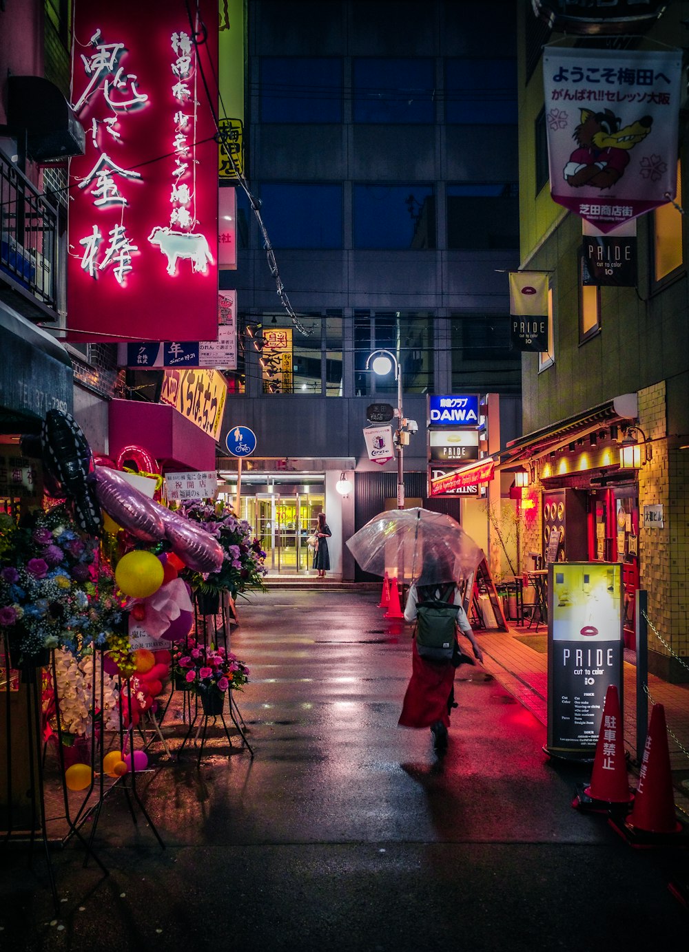 a woman walking down a street holding an umbrella