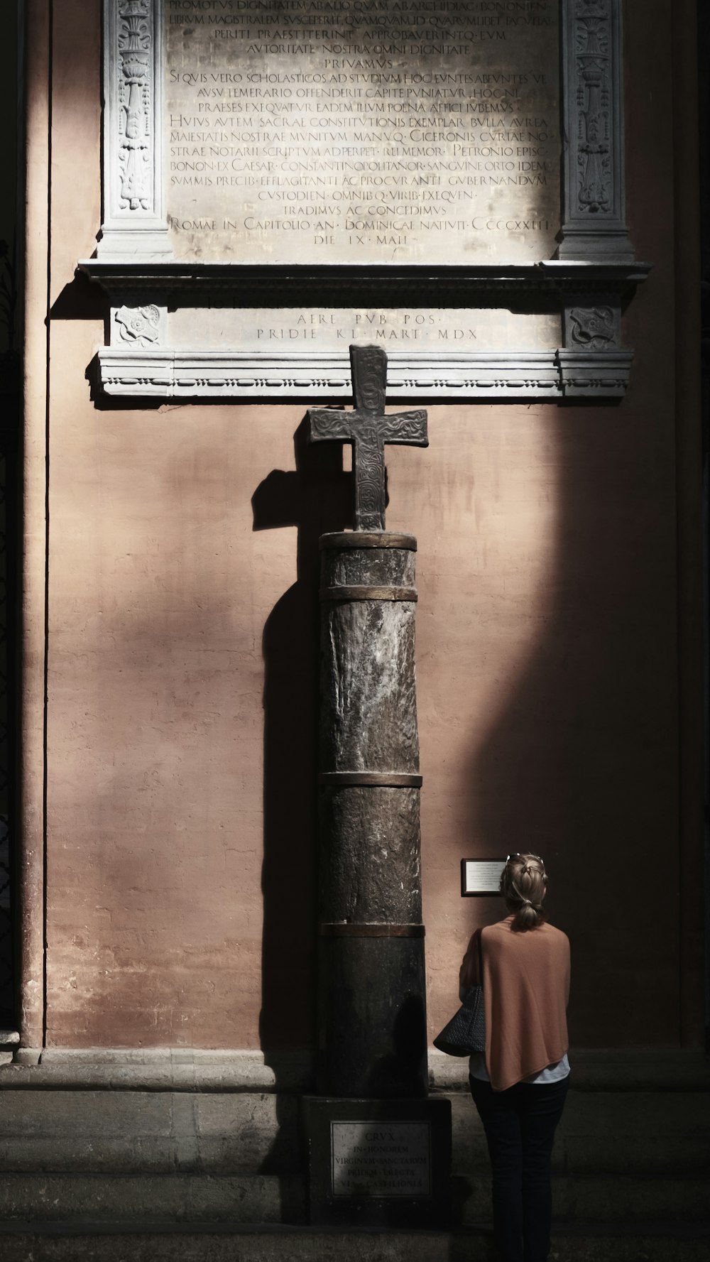 a woman is standing in front of a monument