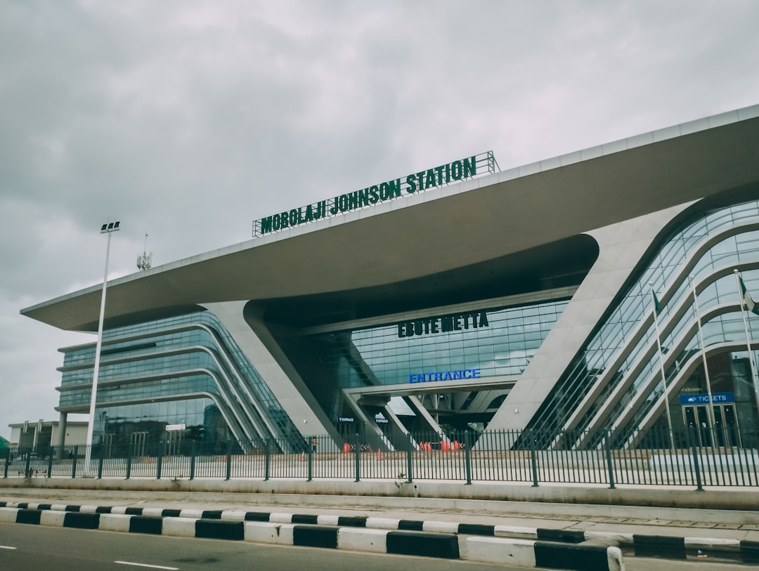 a large building with a sign on top of it, Ebute Metta train station.
