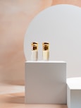 a couple of bottles sitting on top of a white box