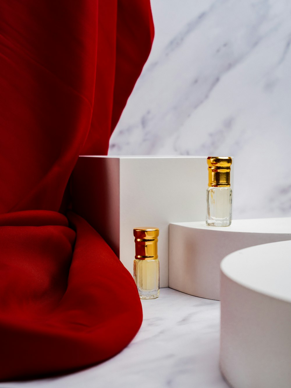 two bottles of perfume sitting on a table