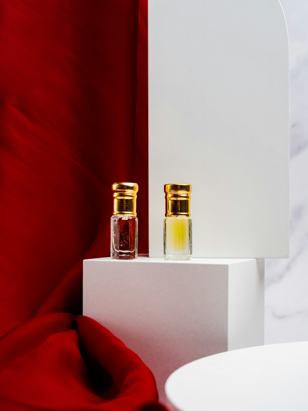 two bottles of perfume sitting on top of a table
