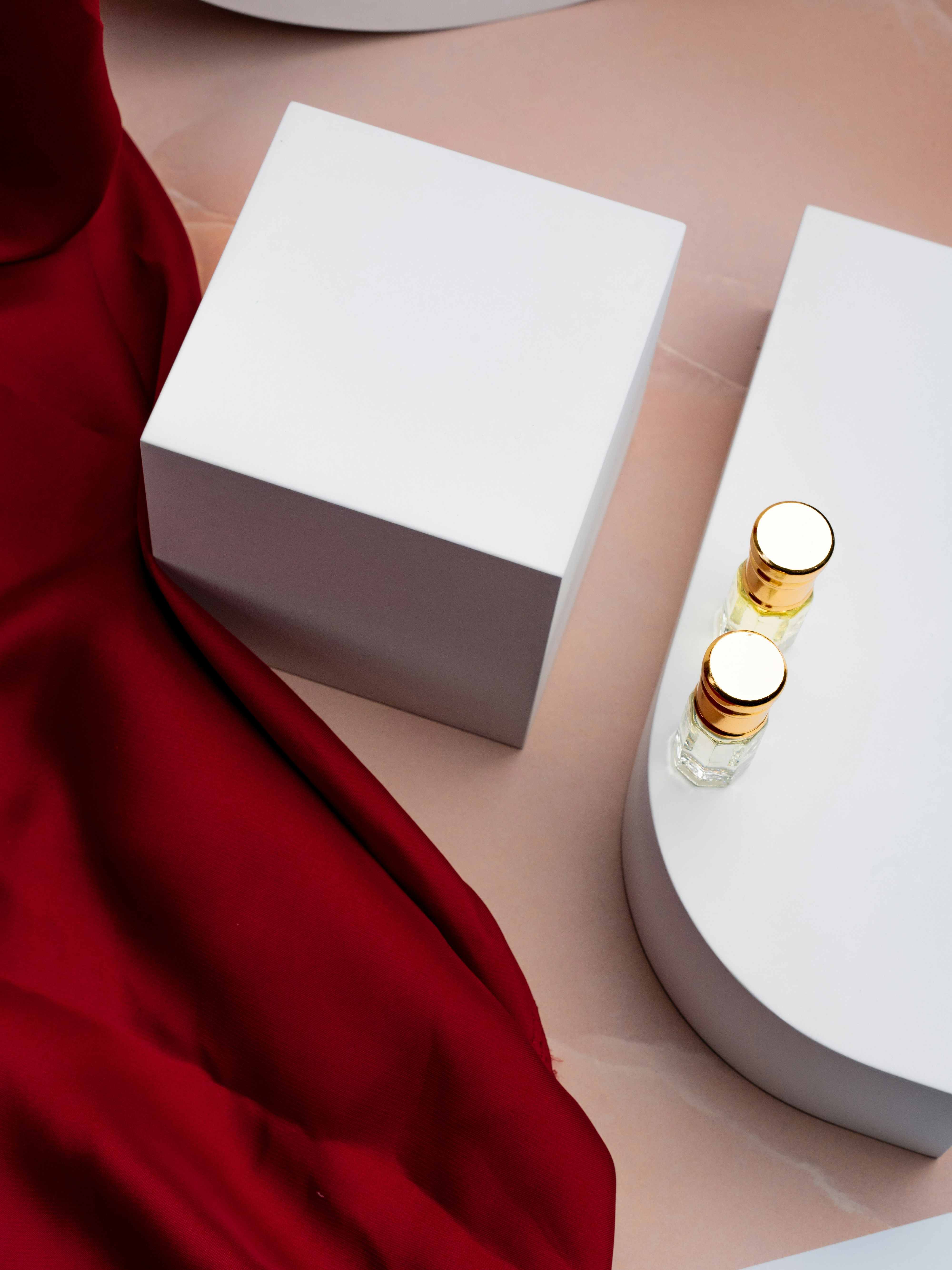 a pair of white candles sitting on top of a table