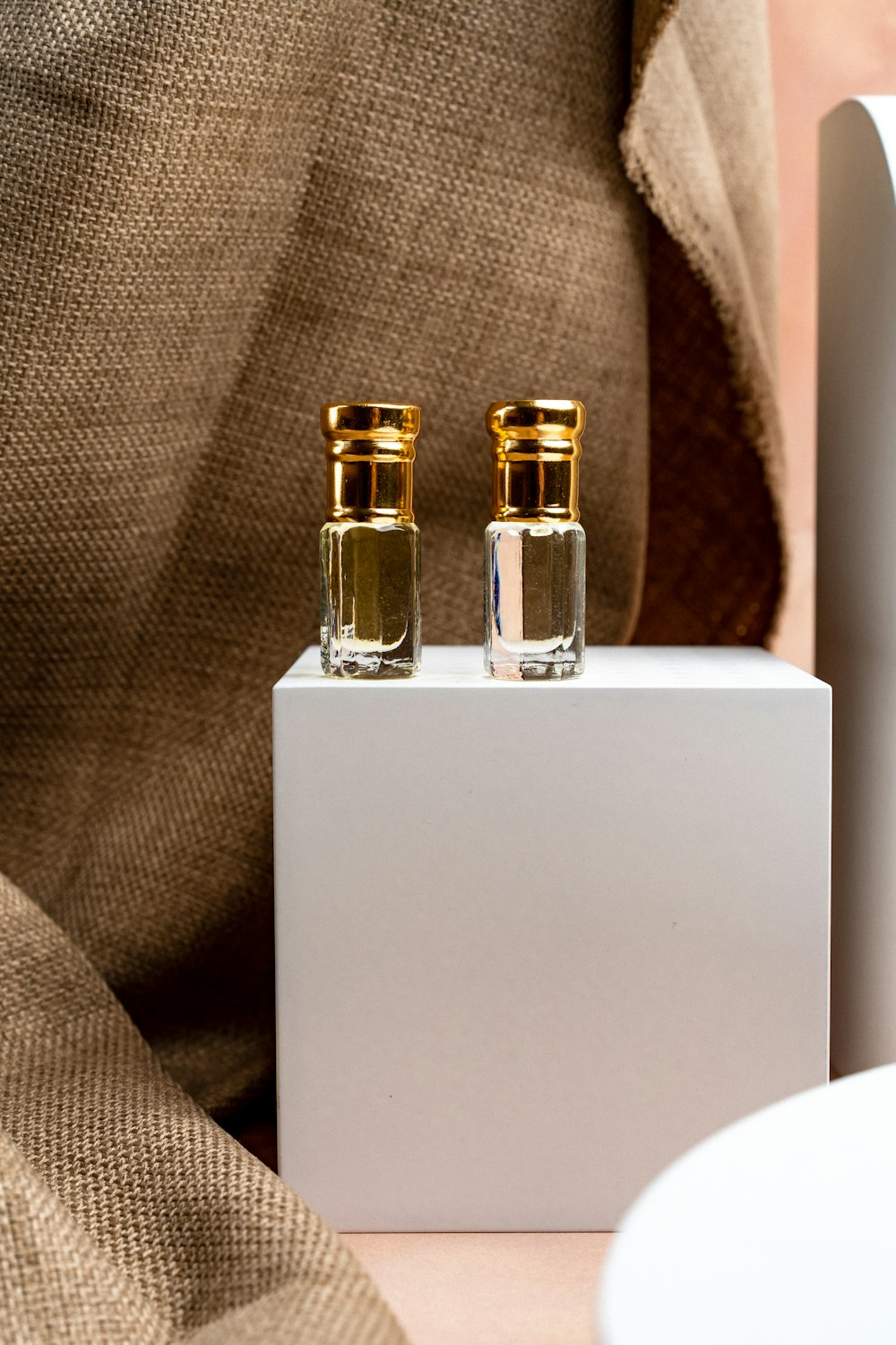 a couple of bottles sitting on top of a white box