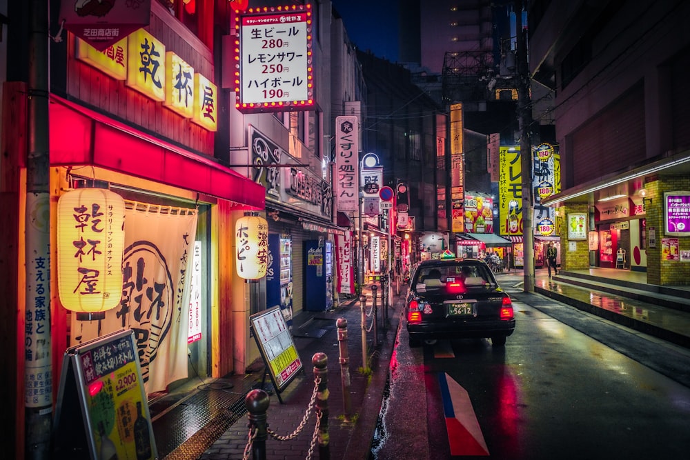 a car driving down a city street at night