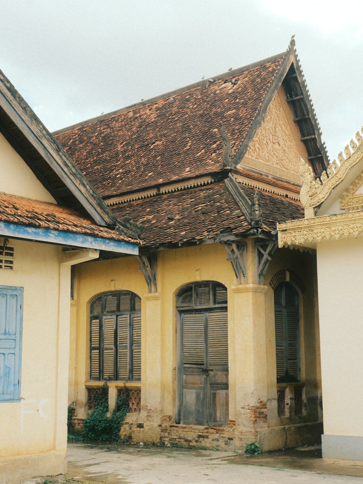 Wat Bo Village Siem Reap — a local Cambodian Buddhist temple with traditional carved wooden eaves and aged shutters, the active pagoda that gives the neighbourhood its name