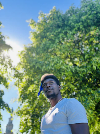 Lifestyle shot of a person wearing a stainless steel necklace outdoors in natural light.