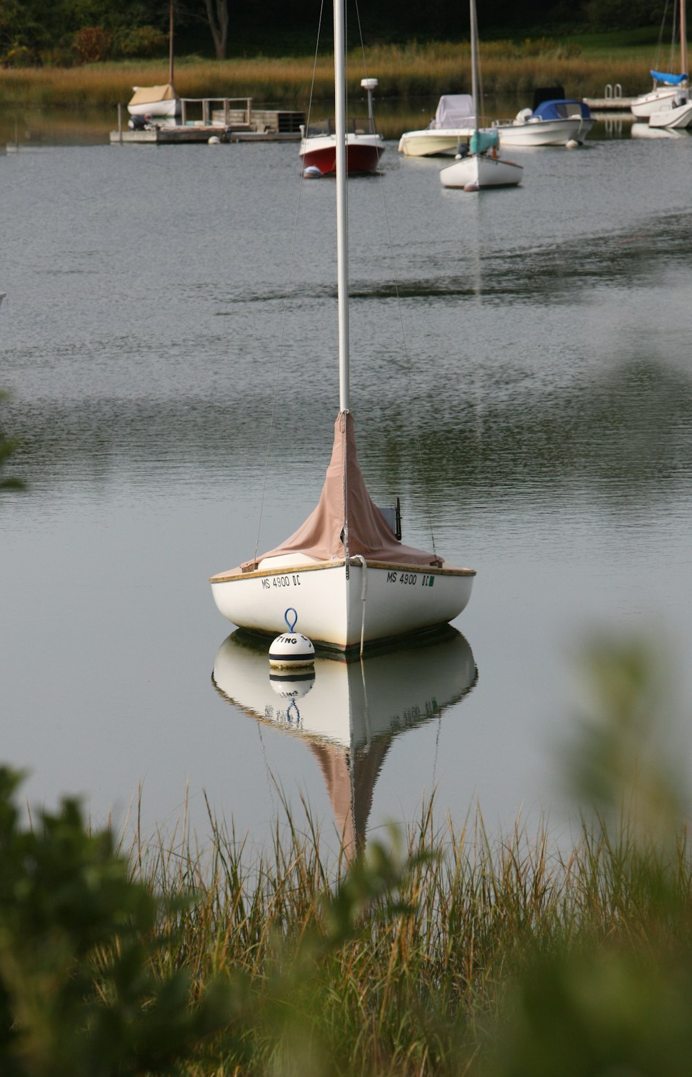 a small sailboat floating on top of a lake
