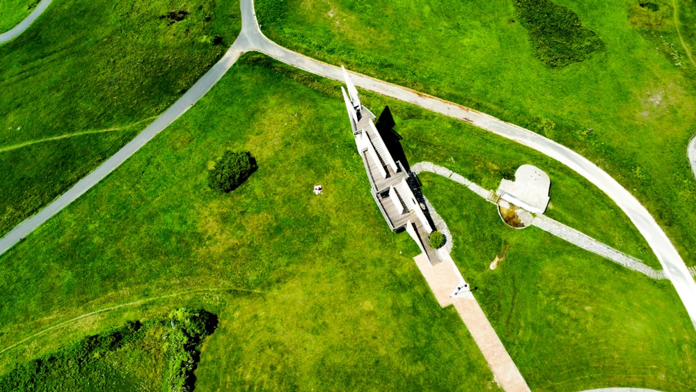 an aerial view of a building in a green field