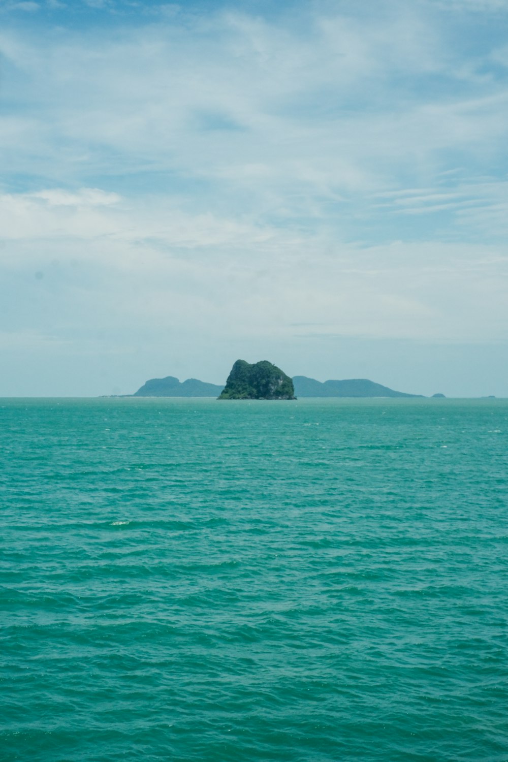 a large body of water with a small island in the distance