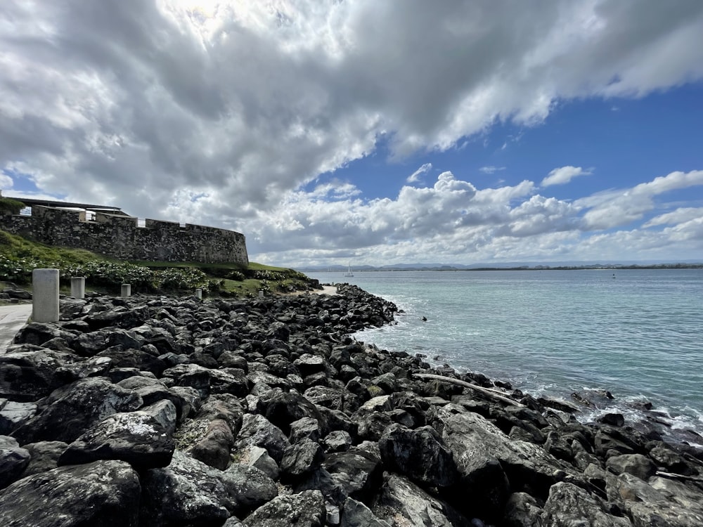 a rocky beach with a large body of water