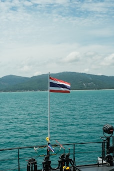 a flag on a boat in the water