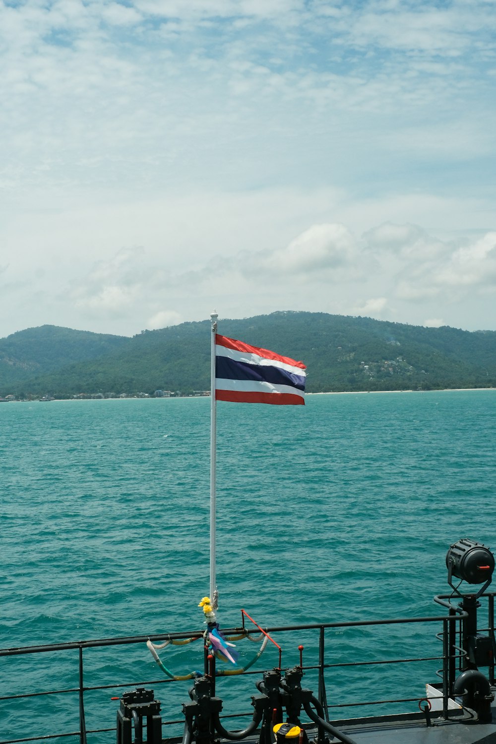 a flag on a boat in the water