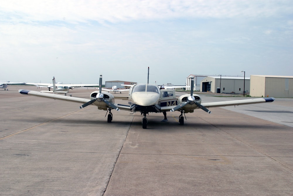 a small airplane sitting on top of an airport tarmac