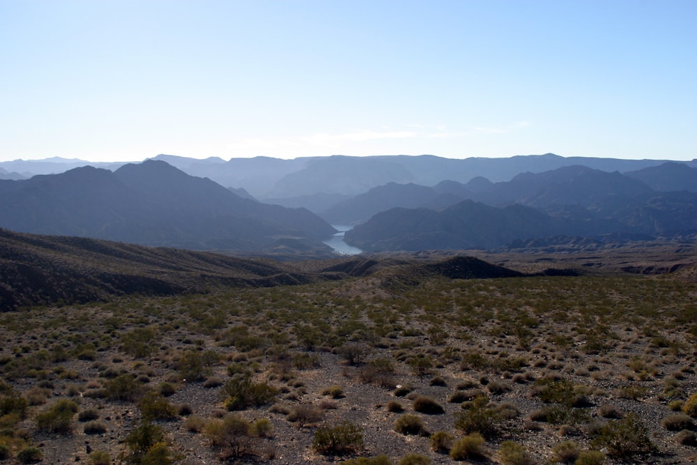 a view of a valley with mountains in the background