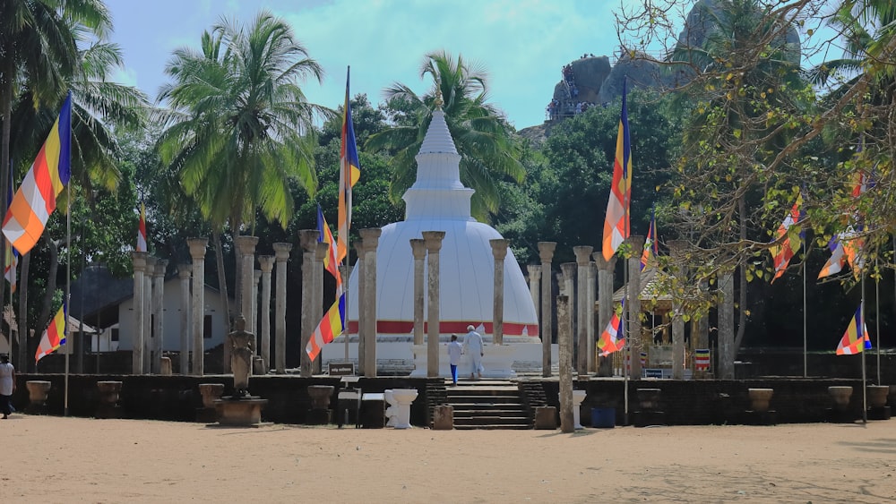 a large white building surrounded by palm trees