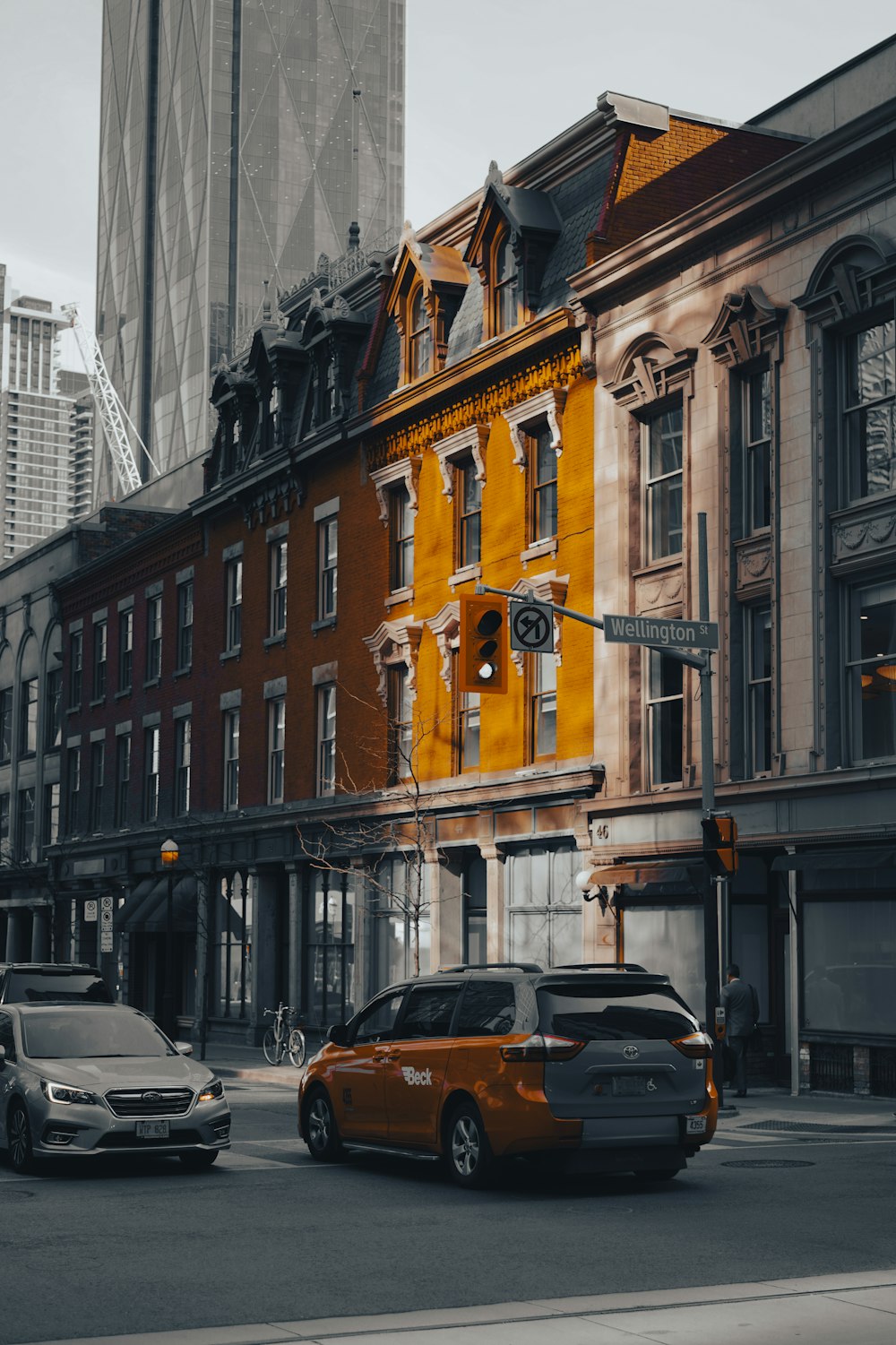 a car driving down a street next to tall buildings