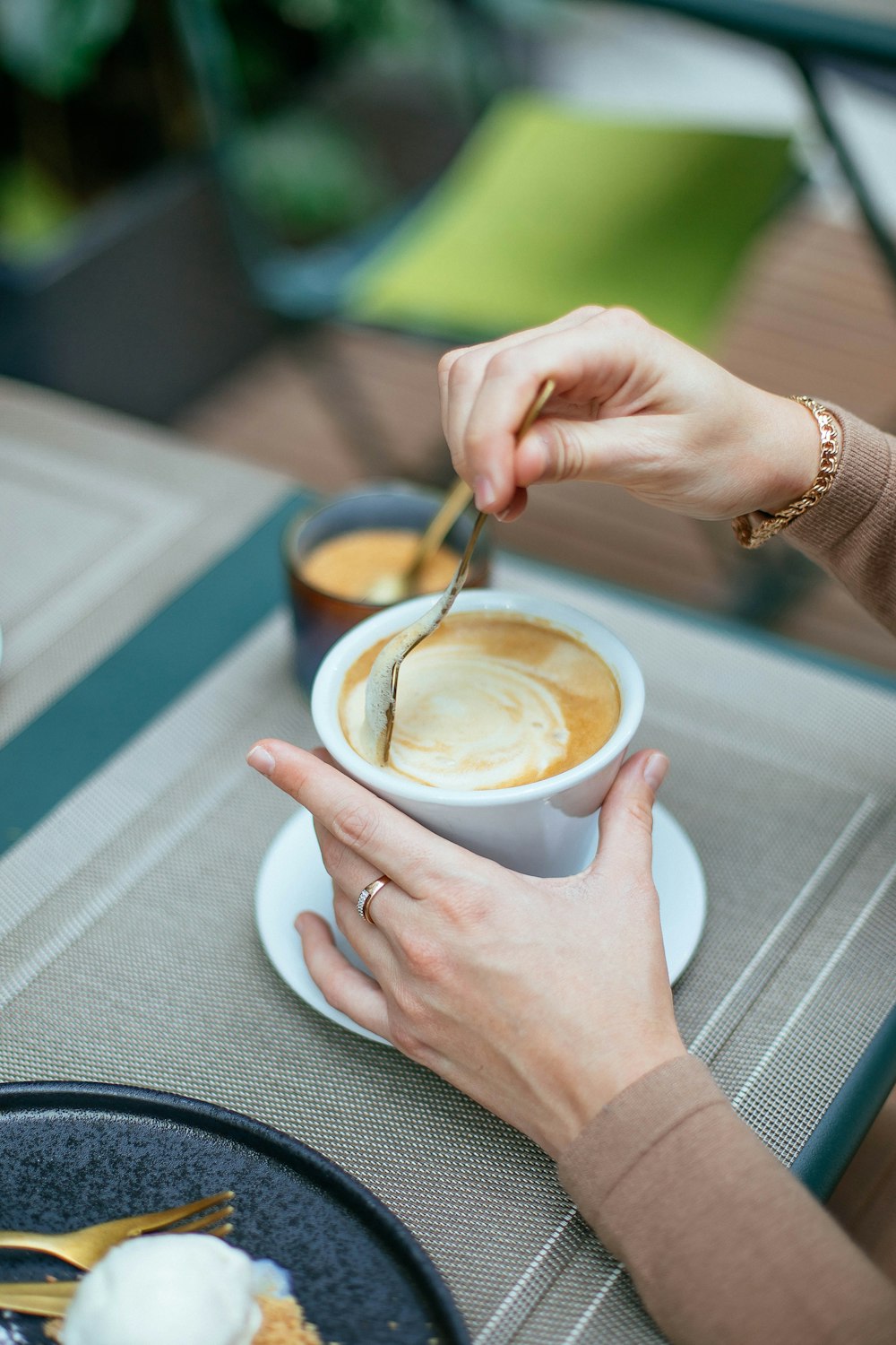 a woman is eating a cup of coffee