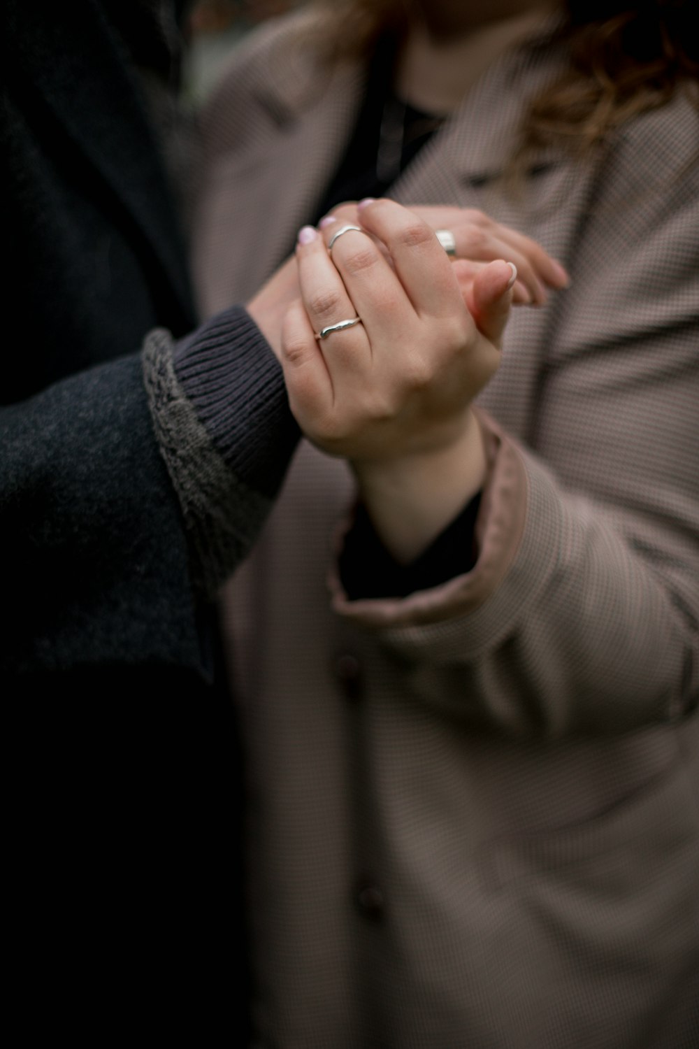 a man and a woman holding hands together