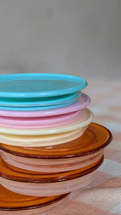 Stacked transparent packaging trays with a subtle blue tint, reflecting light softly.