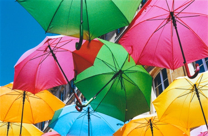 a group of colorful umbrellas hanging from a building