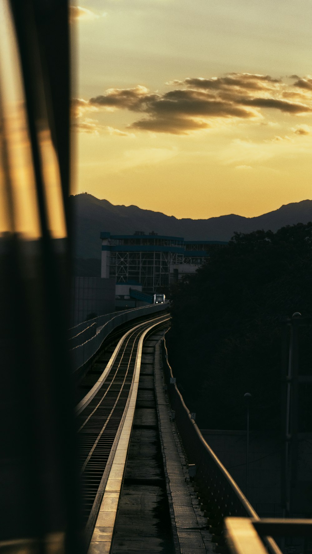 a train traveling down train tracks next to a mountain