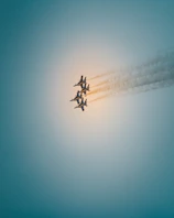 A dynamic shot of multiple planes flying in tight formation over a sunlit horizon.