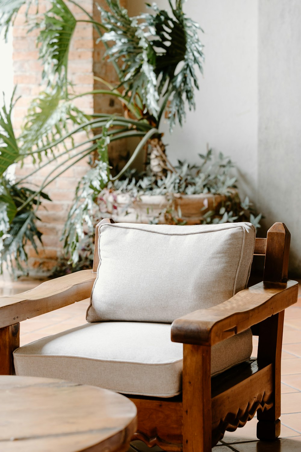 a wooden chair with a white pillow on top of it