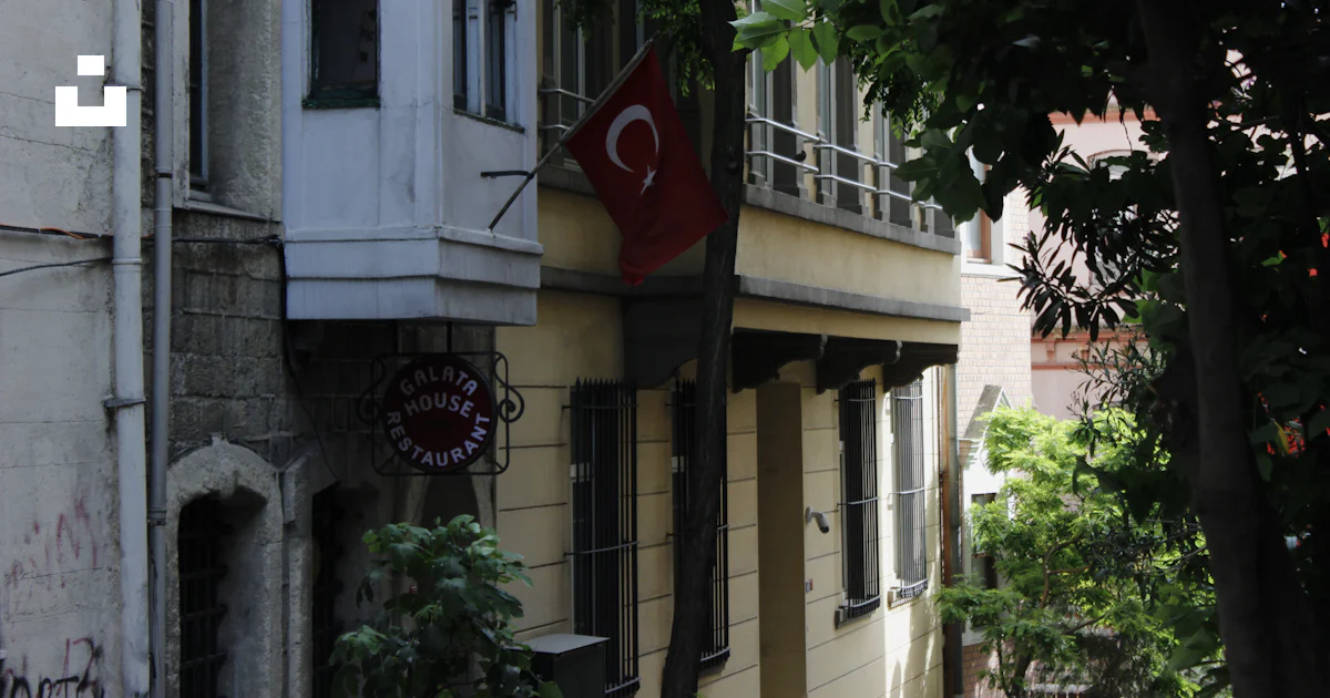 A Building With A Flag Hanging Off The Side Of It Photo Free Beyo lu a-building-with-a-flag-hanging-off-the-side-of-it-photo-free-beyo-lu
