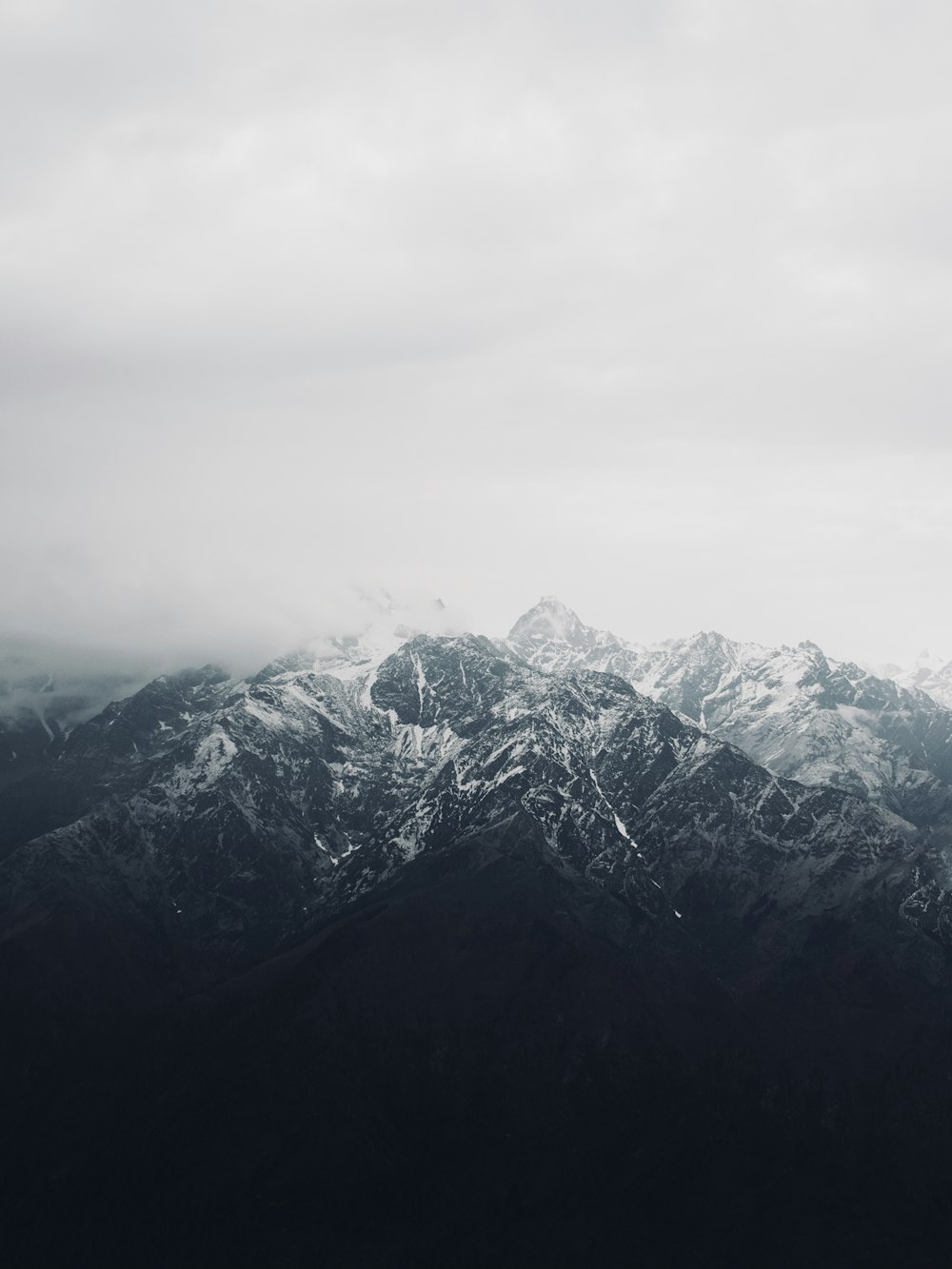 a black and white photo of a mountain range