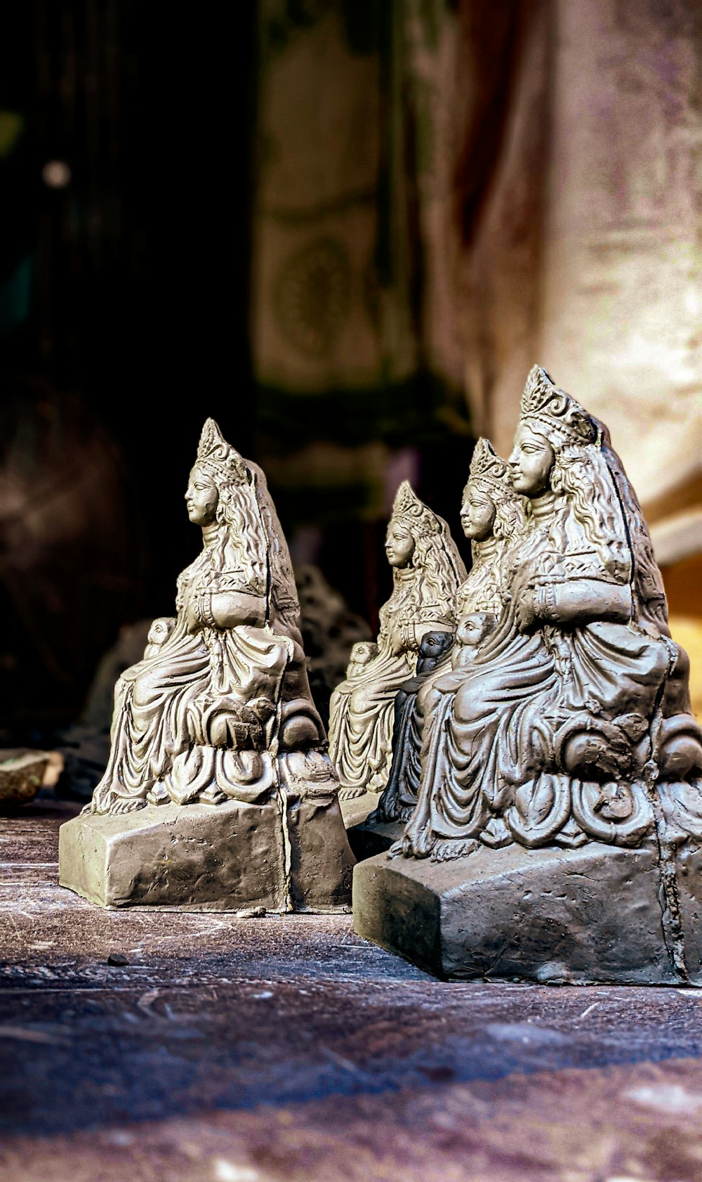 a couple of statues sitting on top of a floor