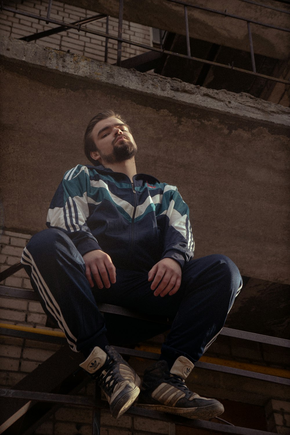 a man sitting on top of a stair case