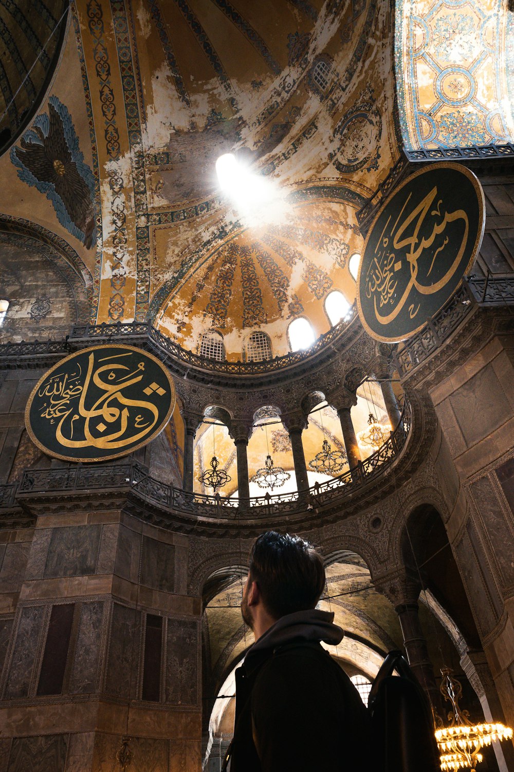 a man standing inside of a building under a dome