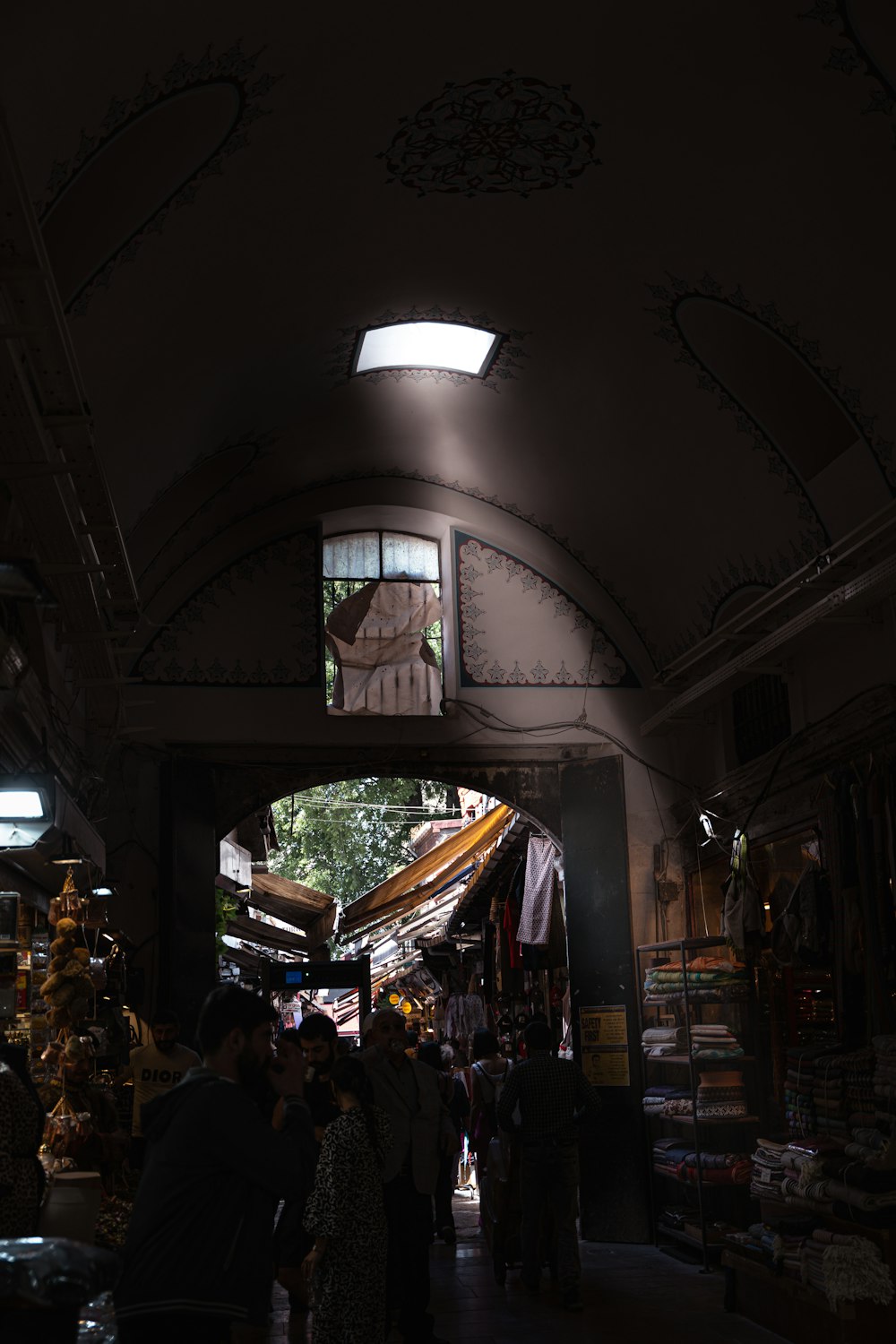 a group of people standing under a clock in a building