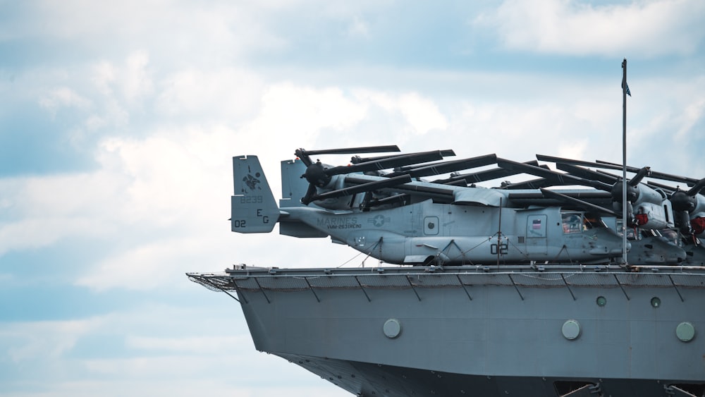 a military helicopter sitting on top of a ship