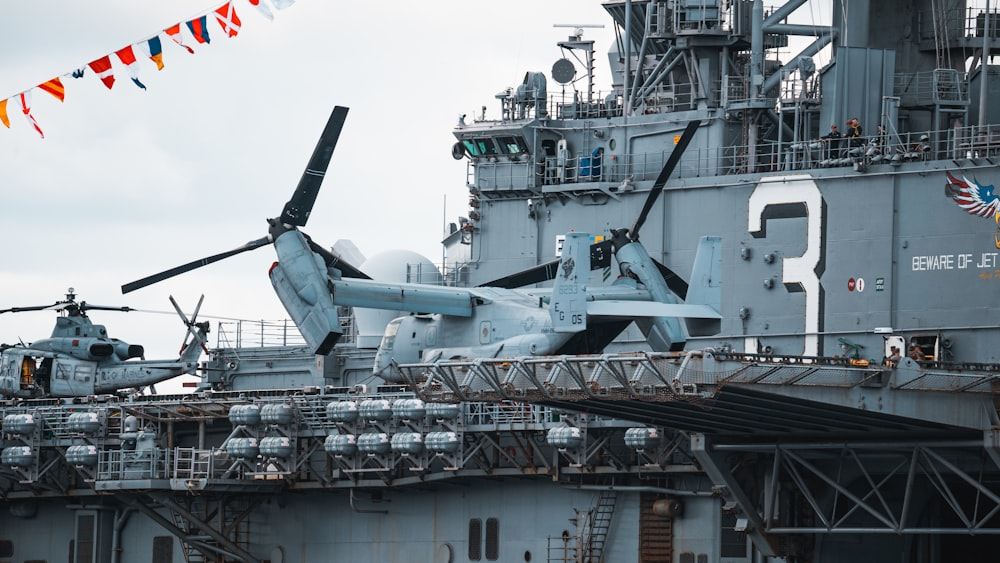 a helicopter sitting on top of an aircraft carrier