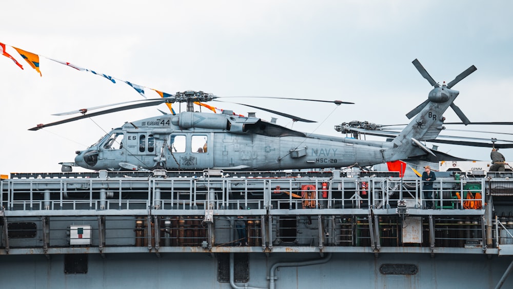 a helicopter sitting on top of an aircraft carrier