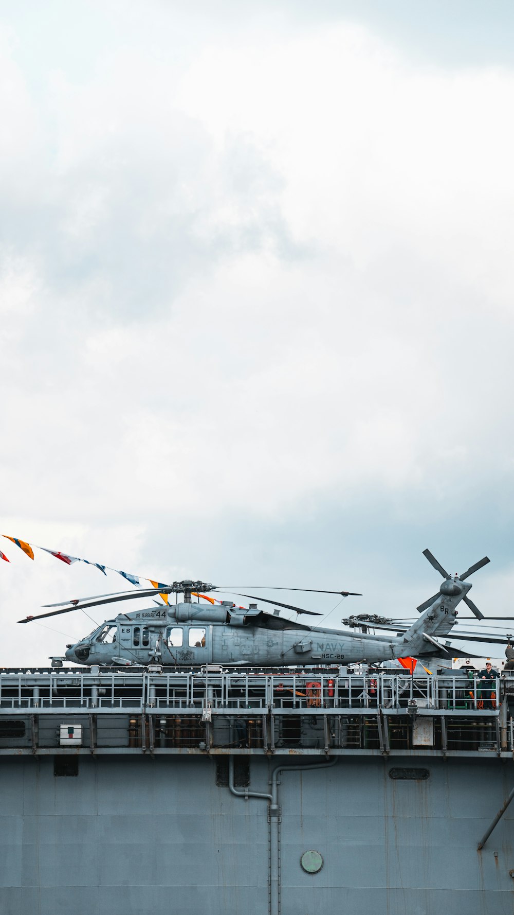 a helicopter sitting on top of an aircraft carrier