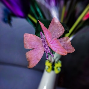 Close-up of an intricately painted butterfly on a handcrafted decorative frame in soft lilac tones