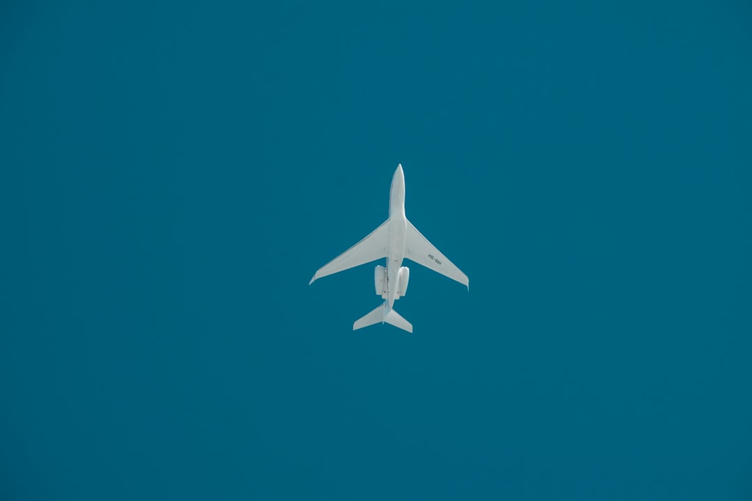 White jet flying in blue sky