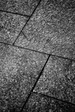 Close-up of artisan laying elegant stone tiles in a contemporary office space.