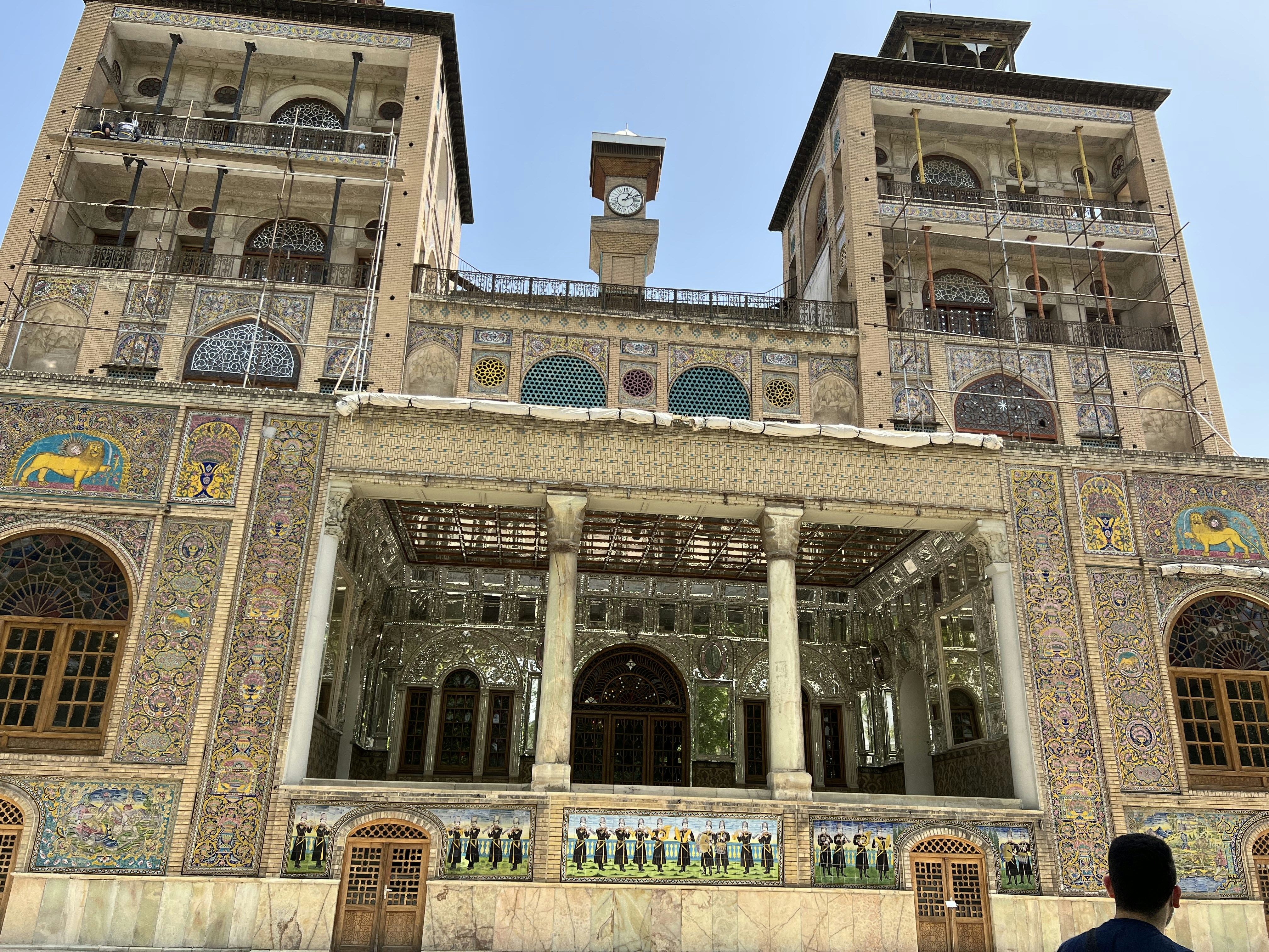 a man standing in front of a large building