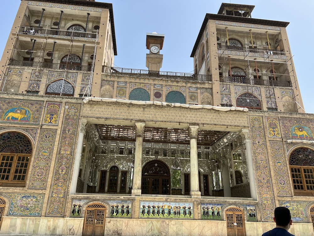 a man standing in front of a large building