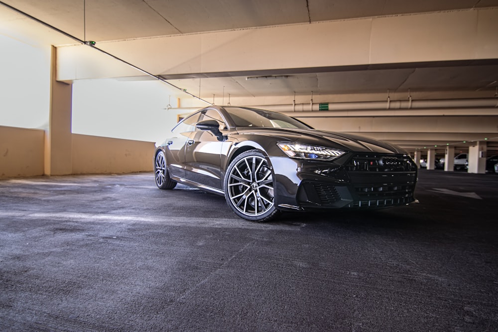 a black car parked in a parking garage