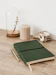 a green notebook sitting on top of a wooden table